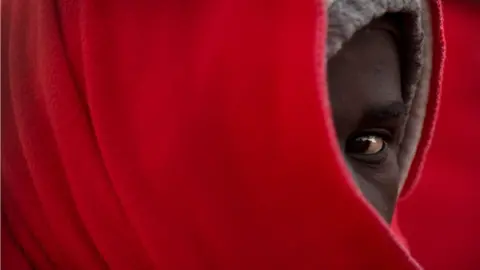 Getty Images A migrant awaits disembarking upon their arrival at the harbour of Malaga, Spain - Sunday 6 January 2019