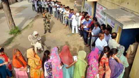 Getty Images Voters line up in Uttar Pradesh state