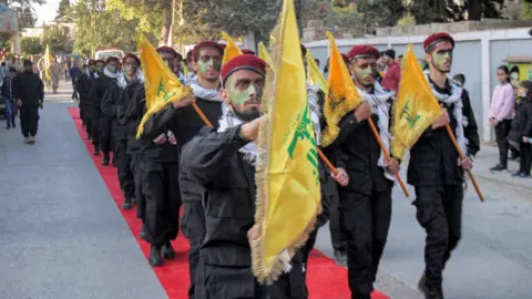 Getty Images Hezbollah members march in Baalbek, Lebanon (13/11/21)