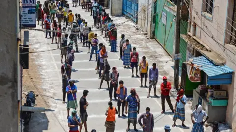 Getty Images waiting for food packages in India