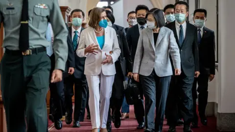 Getty Images Speaker of the U.S. House Of Representatives Nancy Pelosi (D-CA), centre left, speaks Taiwan's President Tsai Ing-wen, centre right, after arriving at the president's office on August 03, 2022 in Taipei, Taiwan. Pelosi arrived in Taiwan on Tuesday as part of a tour of Asia aimed at reassuring allies in the region, as China made it clear that her visit to Taiwan would be seen in a negative light