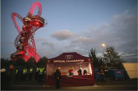 Getty Images A West Ham United official programme stall in front of the ArcelorMittal Orbit at the Olympic stadium during the EFL Cup fourth round match between West Ham and Chelsea at The London Stadium on October 26, 2016 in London, England. (Photo by Catherine Ivill - AMA/Getty Images)