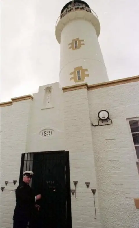 Angus Hutchison, Principal Lightkeeper locks the door of his lighthouse for the last time today (Tuesday).