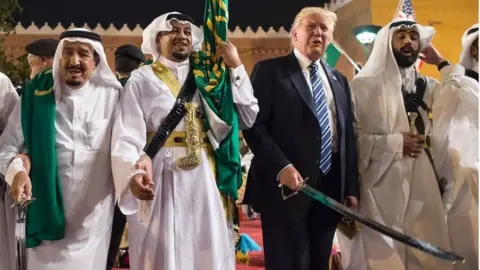 AFP/Getty Images US President Donald Trump (2nd right) and Saudi Arabia's King Salman bin Abdulaziz al-Saud (left) dance with swords at a welcome ceremony in Riyadh. Photo: May 2017