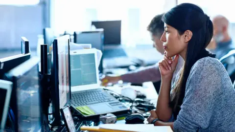 Getty Images People work at computers - stock shot