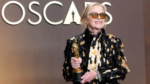 Amy Madigan, winner of the Best Actress in a Supporting Role award for “Weapons”, poses in the press room during the 98th Oscars at Dolby Theatre on March 15, 2026 in Hollywood, California.