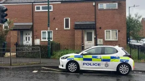 A police car outside a house in Hartley Road, Radford