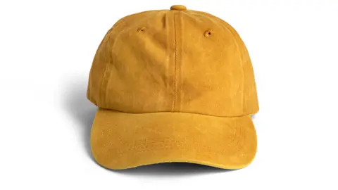 A yellow baseball cap on a white background