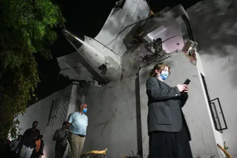 Hindustan Times via Getty Images Investigation team at the site of the Air India flight crash on June 12, 2025 in Ahmedabad, India. 265 people died and many others were injured after the Air India 171 flight headed to London from Ahmedabad crashed moments after take-off. The plane crashed on a resident doctors' hostel in Ahmedabad, which suffered major damage in the accident. (Photo by Raju Shinde/Hindustan Times via Getty Images)