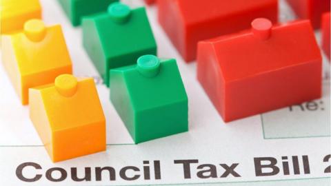 Monopoly pieces on top of a council tax bill
