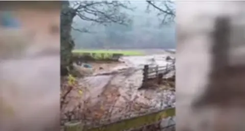 Footage of heavy flooding in a field 