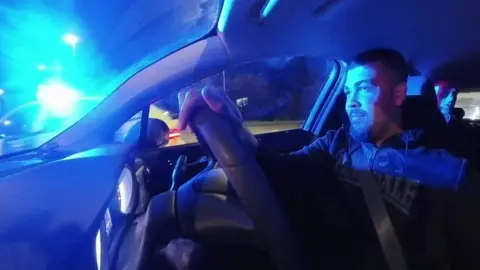 Logan is driving an unmarked police car as an emergency vehicle overtakes 