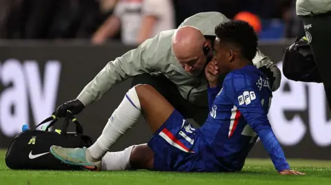 Estevao Willian having treatment on the pitch against Manchester United
