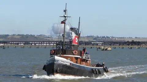 Margaret Flo McEwan A steam tugboat named Challenge is sailing on a river.