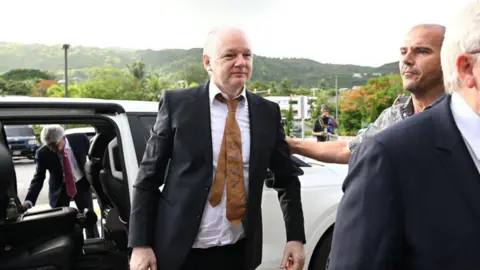 Getty Images WikiLeaks founder Julian Assange arrives for a court hearing at the US Federal Courthouse in the Commonwealth of the Northern Mariana Islands in Saipan, Northern Mariana Islands, on June 26, 2024, after reaching a plea deal with US authorities.