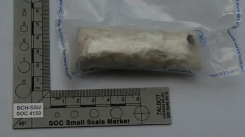 Cambridgeshire Police A pack of drugs next to a ruler