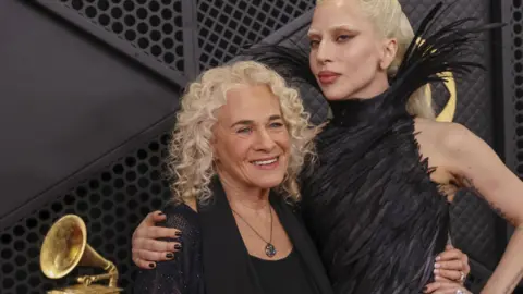 EPA/Shutterstock Carole King and Lady Gaga with their arms around each other on the red carpet