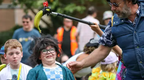 Stockton Borough Council A child looks shocked as a banana "microphone" is held above his head.