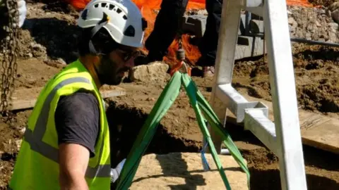 other Stone coffin being unearthed