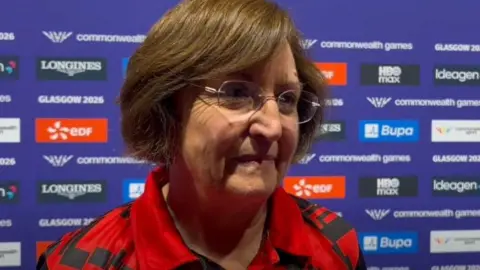 MANX RADIO Caroline Whitehead, who has brown hair in a bob and is wearing glasses.