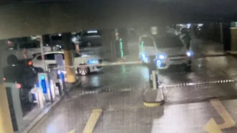 A white car and a white van caught on CCTV in the Mall of Africa shopping centre car park