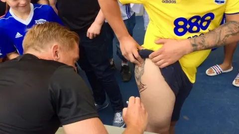 @BCFC Mr Monk signing the tattoo