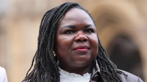 Nurse Jennifer Melle takes part in a show of solidarity with MPs and nurses on College Green outside the Houses of Parliament in Westminster, central London, place ahead of the NHS disciplinary hearing of Christian nurse Jennifer Melle on Tuesday.