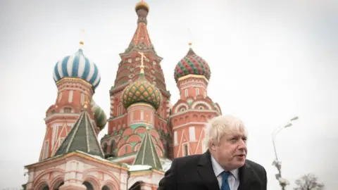 Getty Images Boris Johnson stands in front of St Basil's Cathedral - December 2017