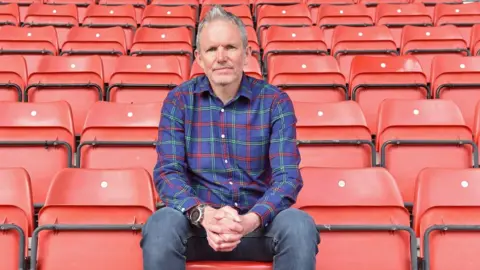 Liam Walsh Liam Walsh sitting in Swindon Town Football Club stadium seating