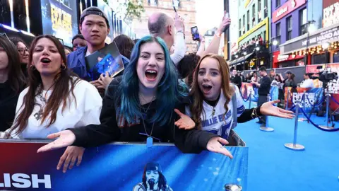 Tim P. Whitby/Getty Images Fans at the premiere scream into the camera.