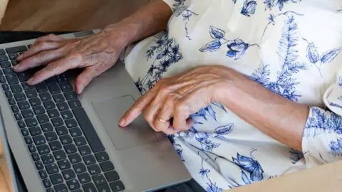 Getty Woman using a laptop