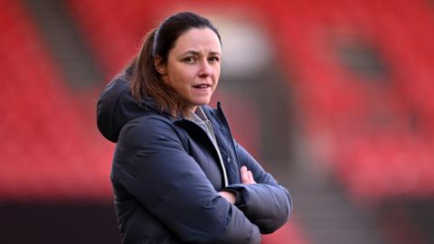 Bristol City manager Lauren Smith stands during a game