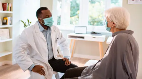 Getty Images An elderly woman seeing her GP