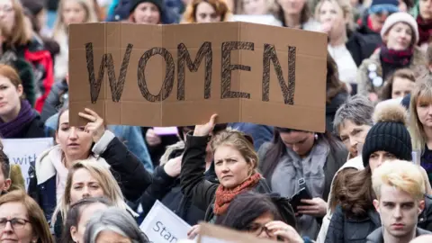 PA People take part in a protest in Dublin after two Ireland rugby players were acquitted