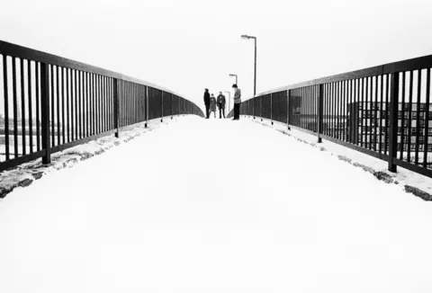 Kevin Cummins Joy Division on Epping Walk bridge, Princess Parkway in Hulme, Manchester