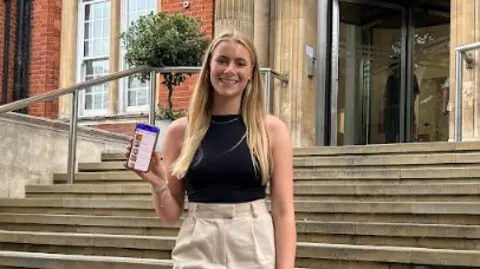 The Ella Dawson Foundation Natasha Dawson shows the Careology app on her phone outside the Royal Marsden Hospital