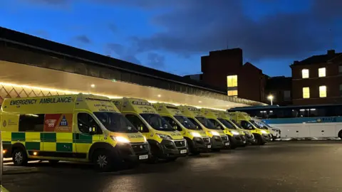 A row of ambulances waiting outside of Glenfield Hospital