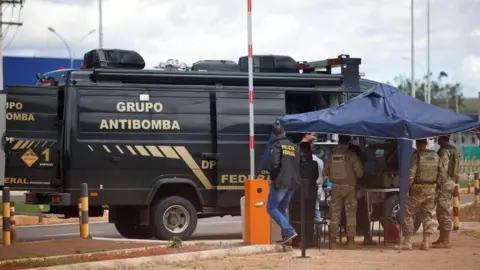 Reuters Security forces work as a robot of the federal police bomb squad is seen near what is believed to be an explosive artifact in Brasilia, Brazil, December 24, 2022.