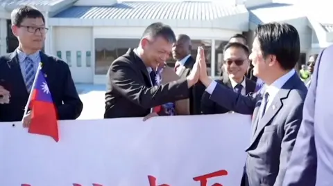 Taiwanese President high-fiving man in suit