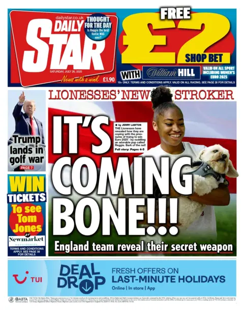 The Star's front page is a photograph of a small dog named Reggie in the arms of Lionesses player Khiara Keating. 