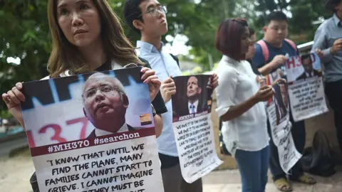 AFP/Getty Images Victims' relatives and their supporters protest against the suspension of the search