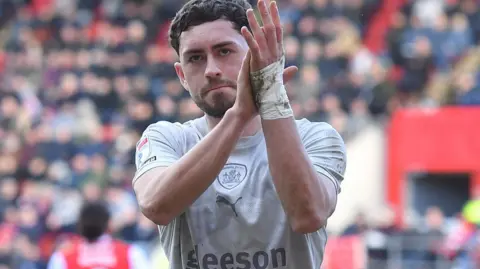 Corey O'Keeffe applauds the Barnsley fans