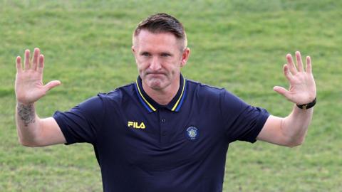 Robbie Keane waves to fans after being unveiled as Maccabi Tel Aviv boss