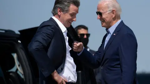 Getty Images Biden and Newsom on the airport