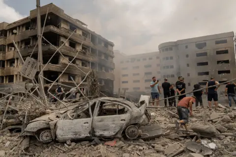 Joel Gunter/BBC An Israeli air strike on the Dahieh neighbourhood destroyed Dr Taghrid Diab's gynaecology clinic, in the building on the left of this picture