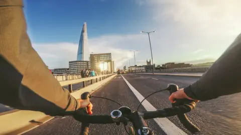 Getty Images Someone cycling over a bridge in London