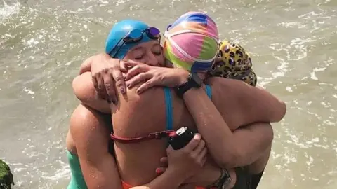 BBC Sport Harriet Green, Natalie Perrett and Billy completed the cross-channel swim at 15:56 BST.