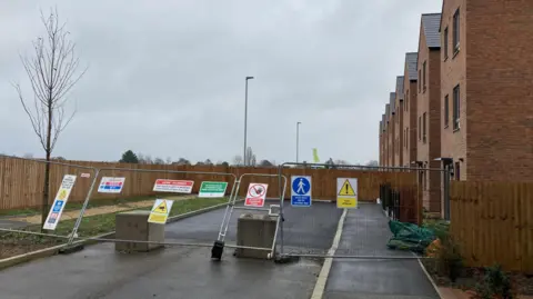 Dave Webster/BBC Fencing separating the homes being lived in and the ones set for demolition