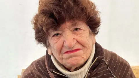 BBC 91-year-old refugee Nina sits an aid centre in Odesa