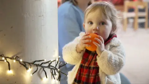 Lydia Hepworth bites an orange